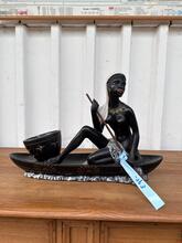 Antique Statue of a woman in a canoe