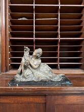 Antique style Statue og a reclining woman and a dog