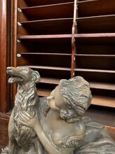 Antique style Statue og a reclining woman and a dog